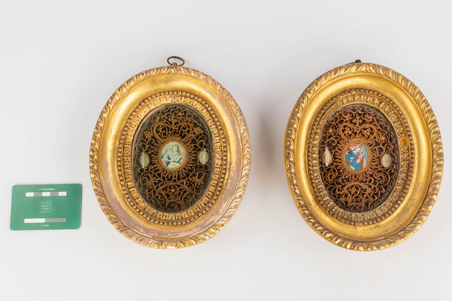 A pair of framed relics, decorated with images of Mary and Joseph with child. 19th C. (W: 19 x H: 23 cm)