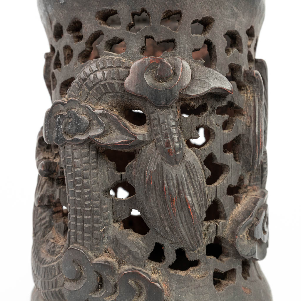 An ajoured vase made of sculptured hardwood with a dragon and foo dog. (H:20,5cm)