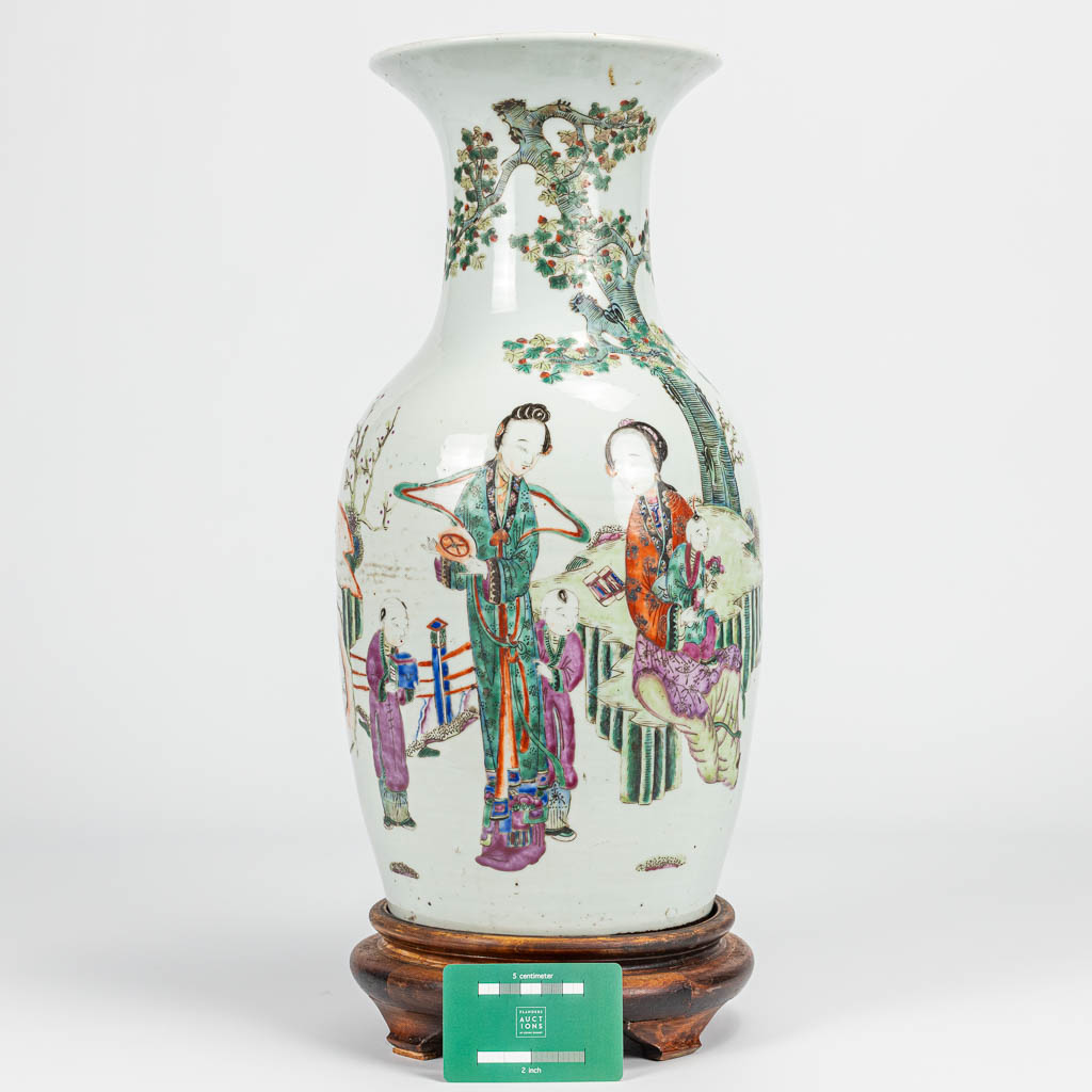 A vase made of Chinese porcelain decorated with ladies, children and bats