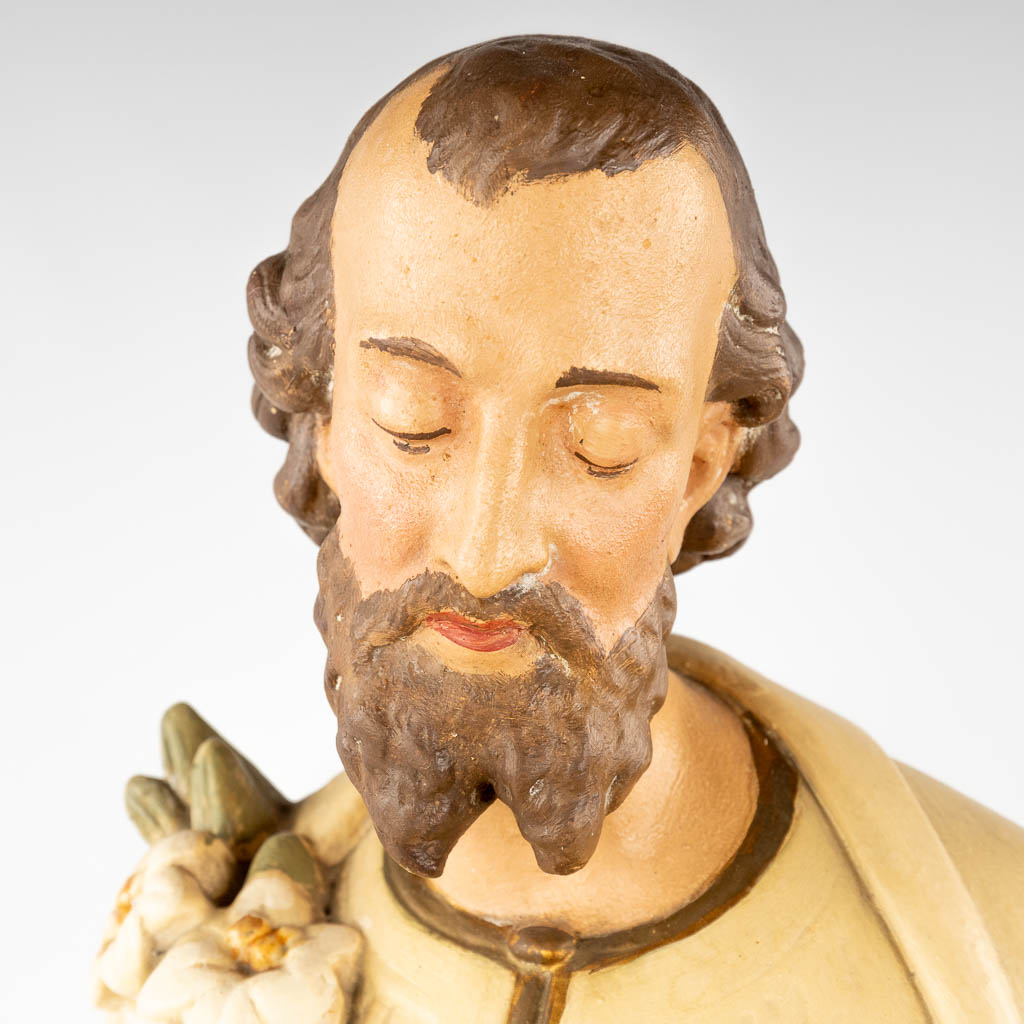 A large figurine of Joseph with Child, made of patinated plaster. Circa 1900. (H: 86 cm)