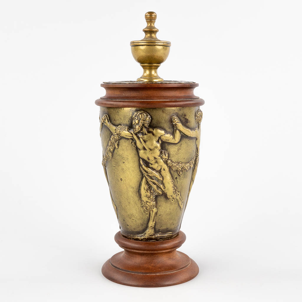 An antique bronze ornament, decorated with a dancing Satyr and lady, mounted on pear wood. 19th C. (H: 24 x D: 10 cm)