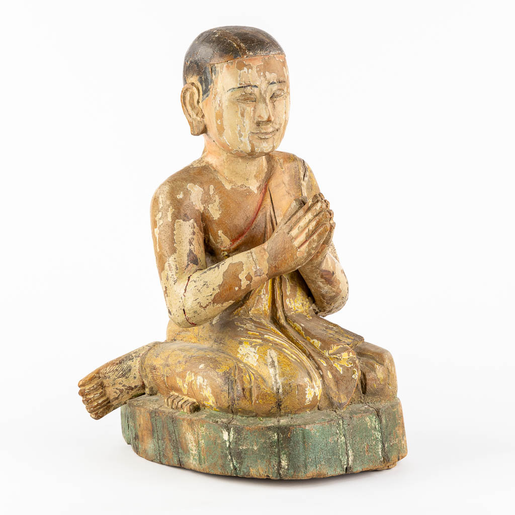 An antique wood-sculptured figurine of a monk. 18th/19th C. (L:36 x W:30 x H:47 cm)