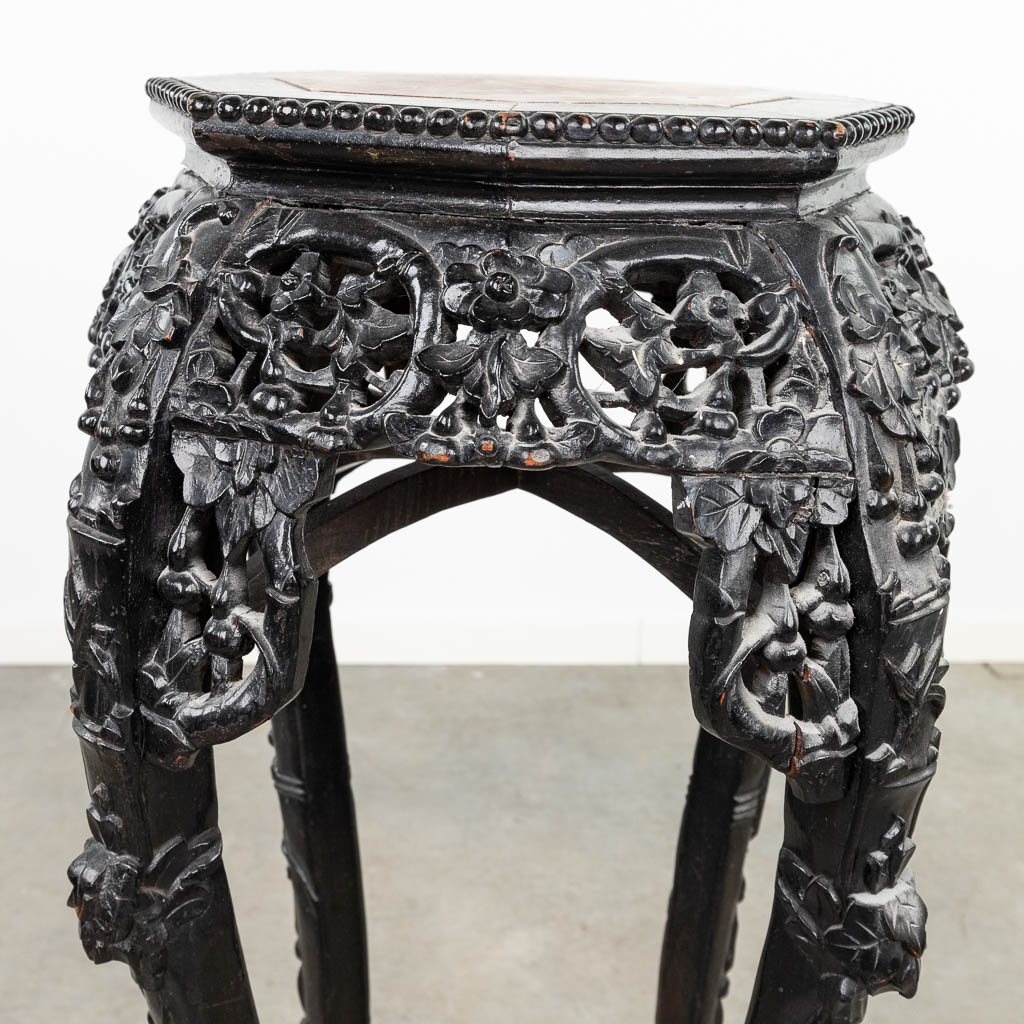 An Oriental high planter, made of hardwood and finished with marble. (L: 52 x W: 52 x H: 91 cm)