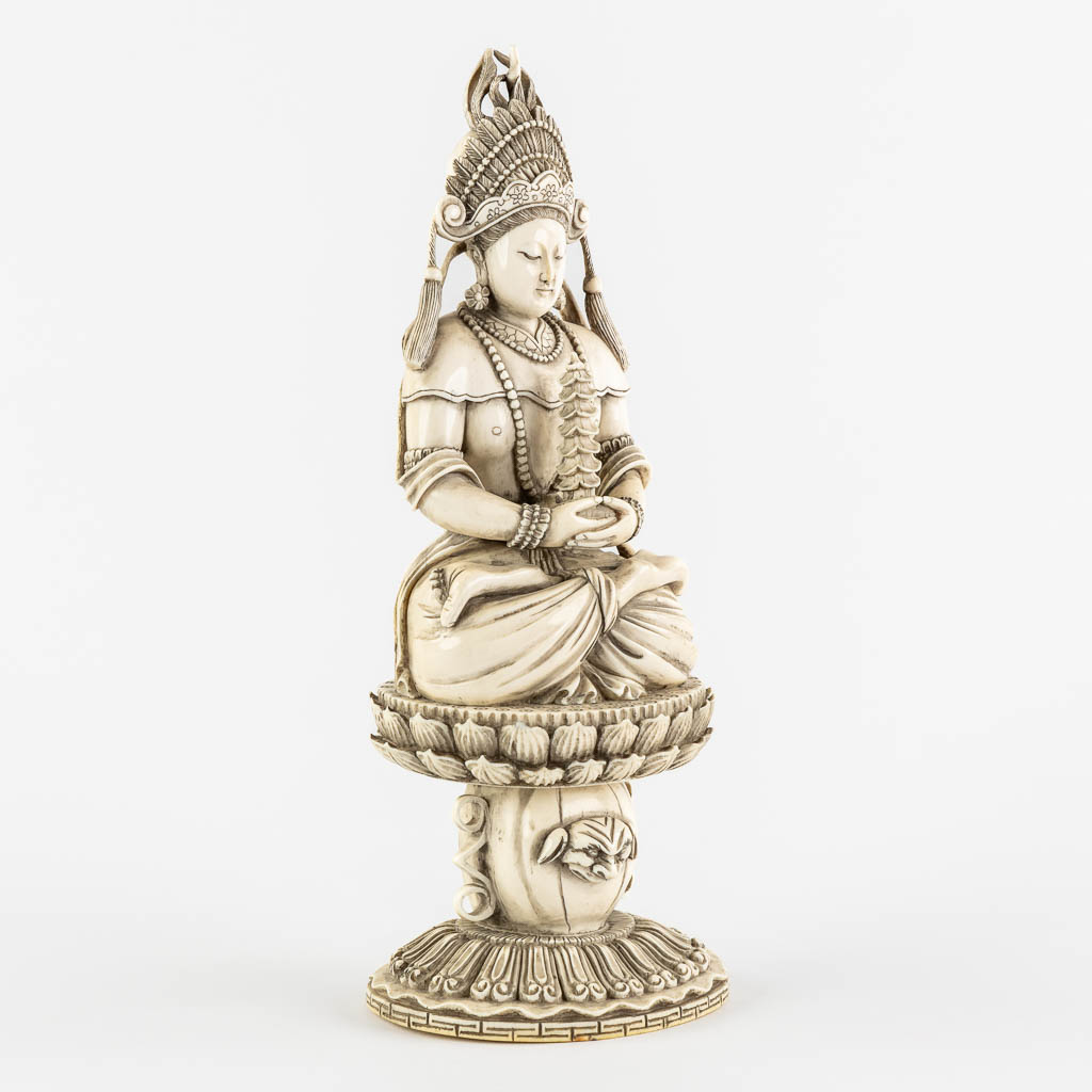 A Chinese Buddha holding a Pagoda, sculptured ivory. Circa 1900. (L:10 x W:12 x H:31 cm)