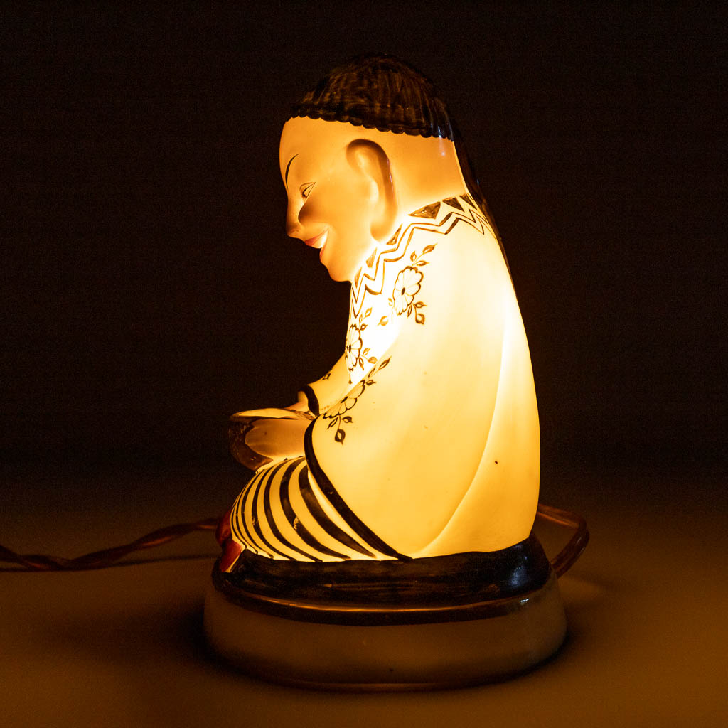 An insence burner in the shape of a Chinese figurine, interior with a lamp. Circa 1920. (L: 9 x W: 12 x H: 16 cm)