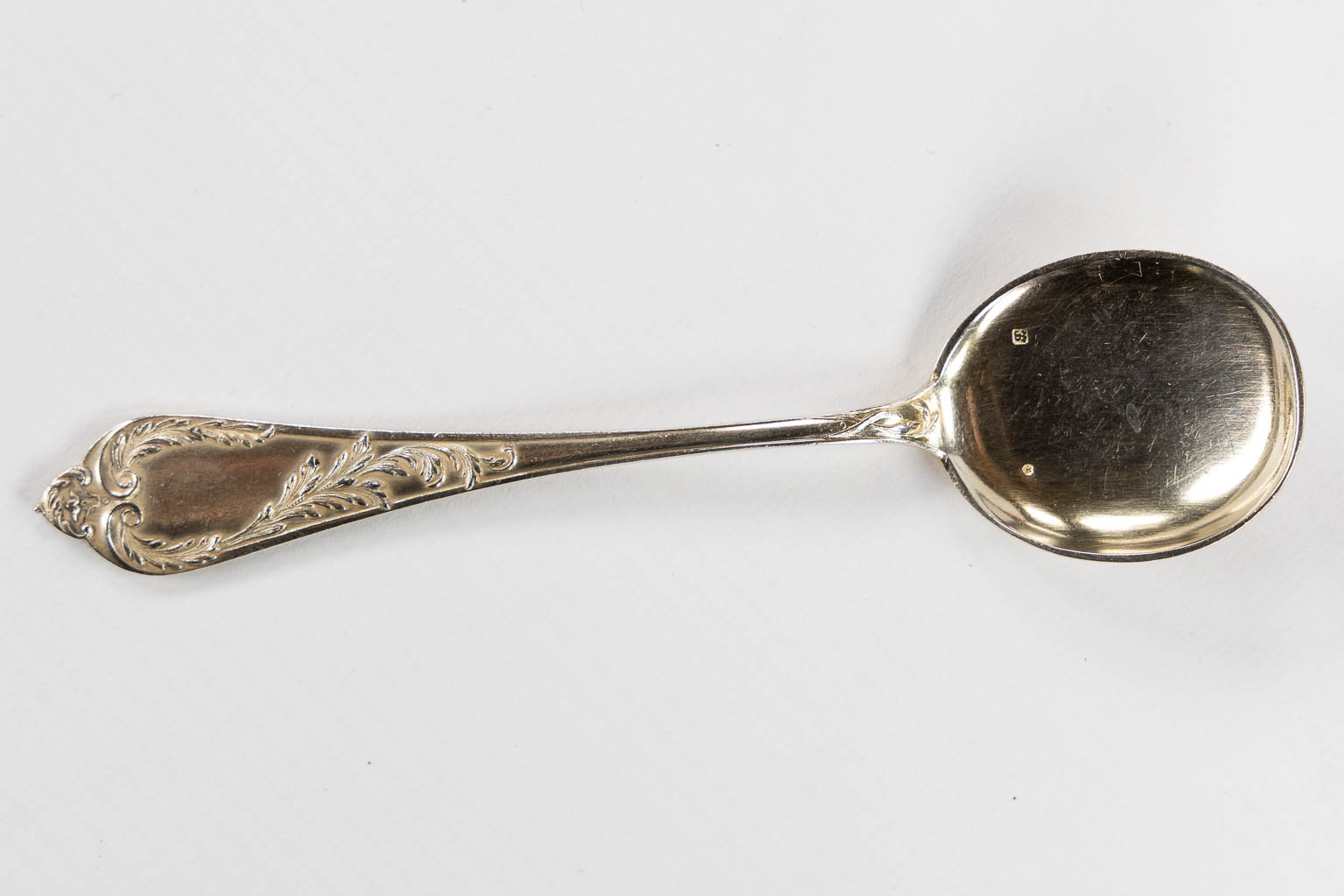 A large collection of silver-plated cutlery, added 12 Delheid silver ice spoons, 309g. 