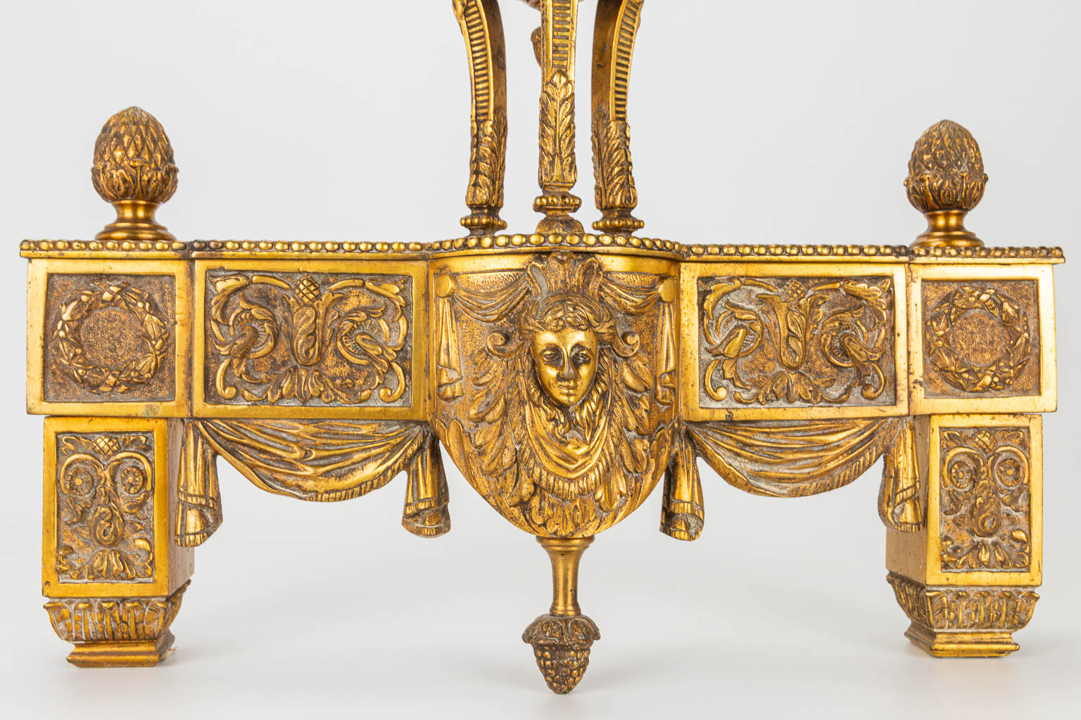 A pair of fireplace andirons made of bronze in Louis XVI style.