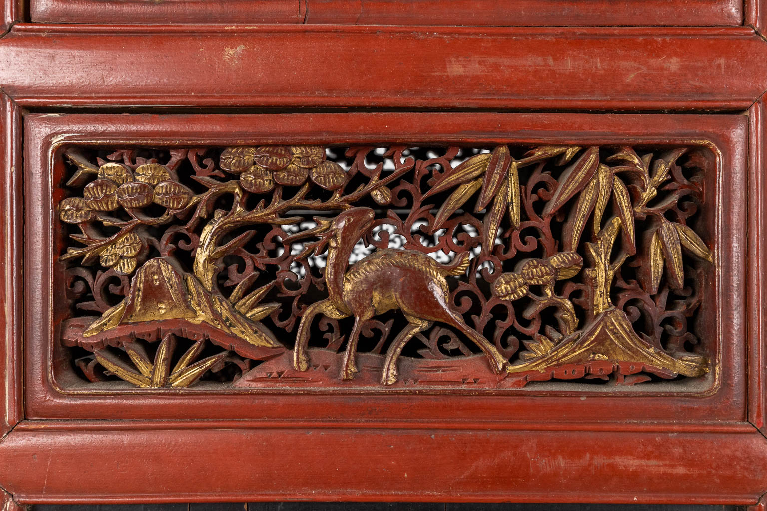 A Chinese cabinet with finely sculptured lacquered and gilt wood panels, 19th/20th C. (D:47 x W:73 x H:173 cm)