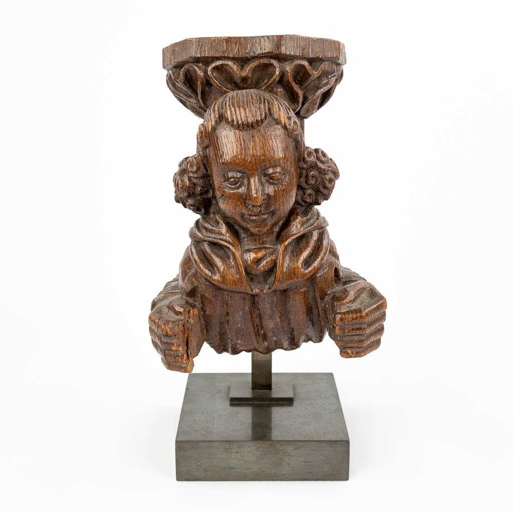  An antique wood sculptured corbel, with a medieval figurine. 19th C.