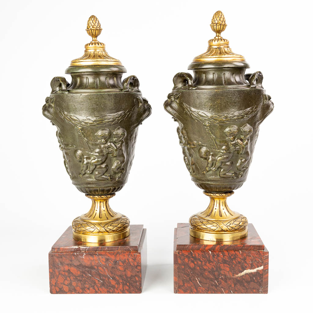 Een paar cassolettes gemaakt uit gepatineerd en verguld brons en versierd met putti