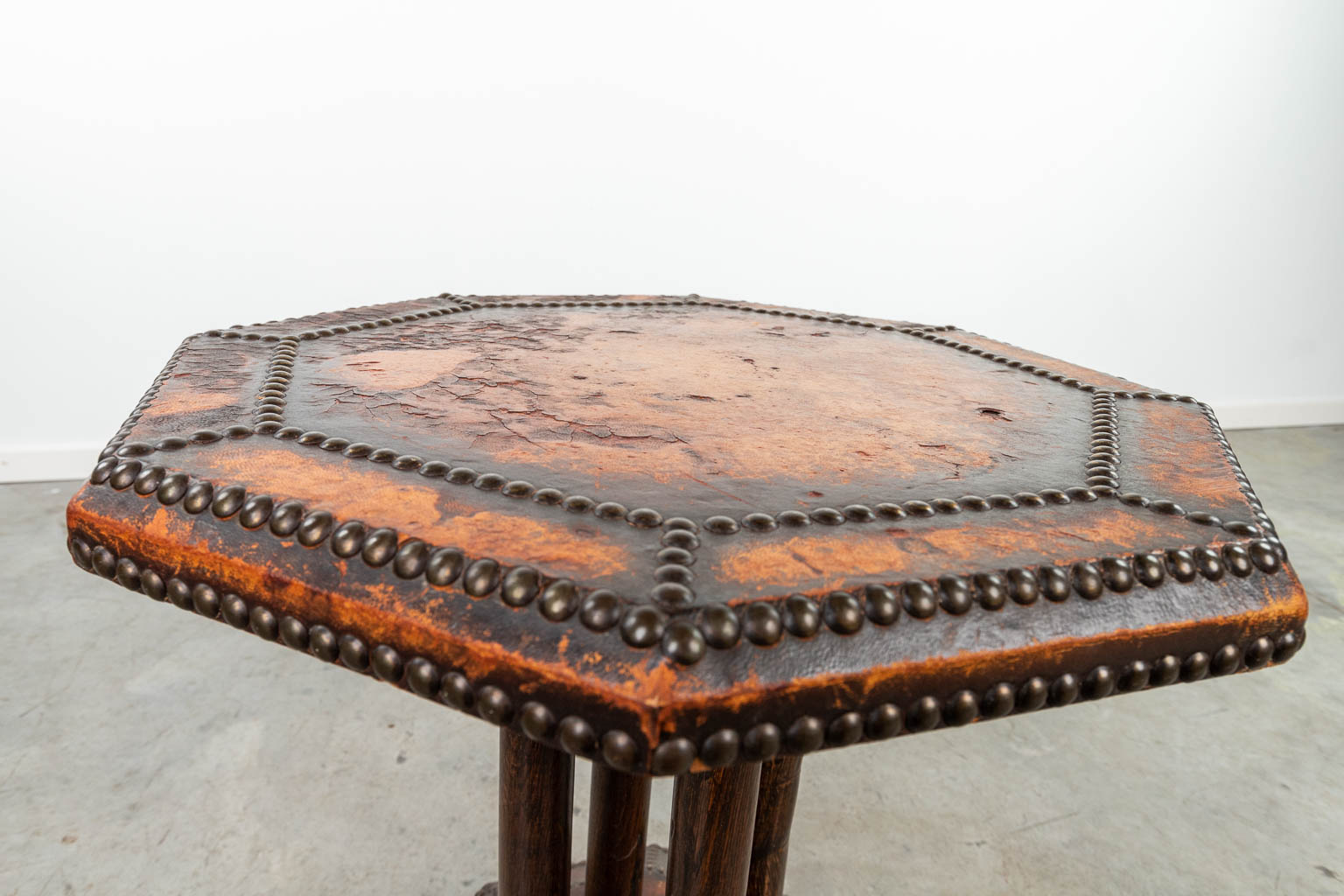 A coffee table made of leather and finished with nails in art deco style. (H:58cm)
