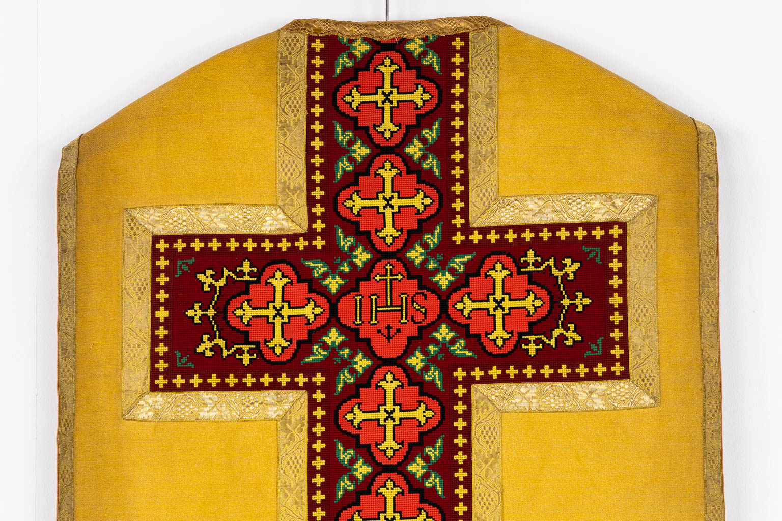 A Humeral Veil and Four Roman Chasubles, embroideries with an IHS and floral decor. 