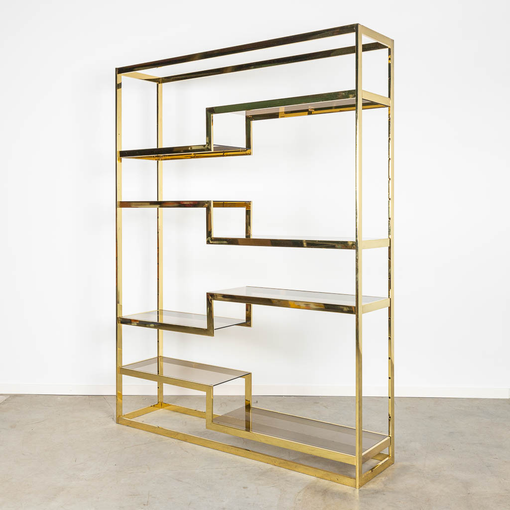 A mid-century etagère shelf or room divider, made of gold plated metal