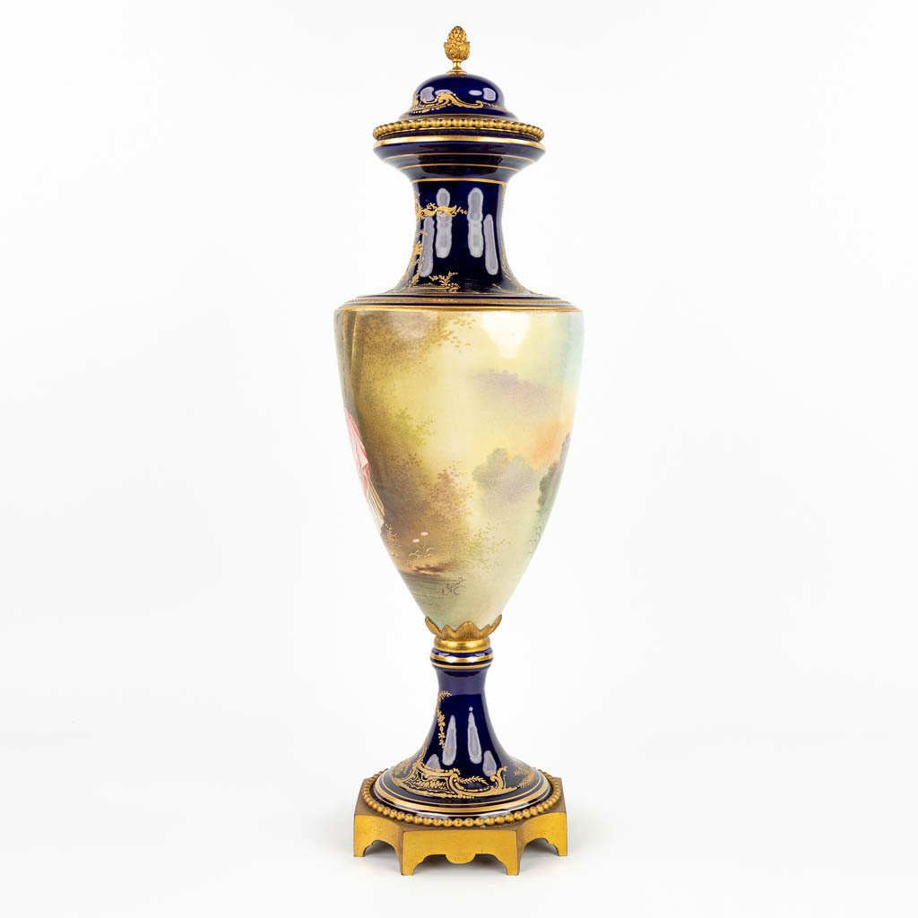 A vase with a hand-painted romantic decor, made by Sèvres and signed E. Grisard. (H:71cm)
