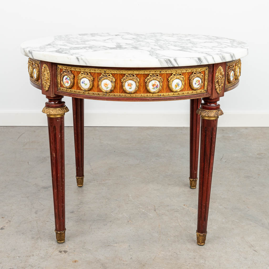 A coffee table with marble top and plaques made of porcelain. (H:49cm)