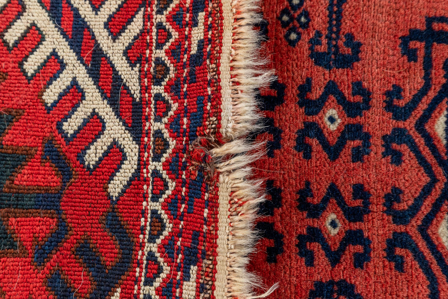 An Oriental hand-made carpet. (D:226 x W:119 cm)