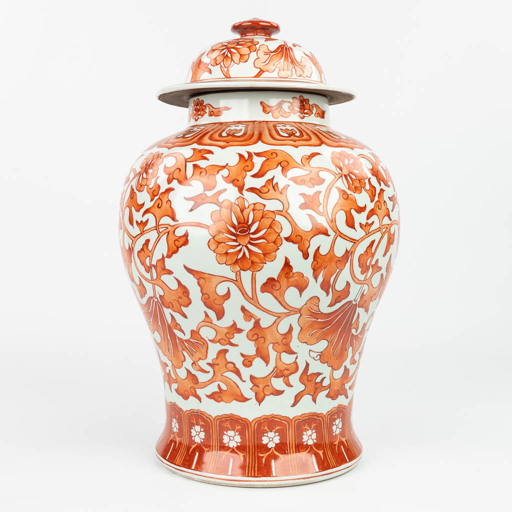 A Chinese vase made of porcelain and decorated with red floral decor. (H:39cm)