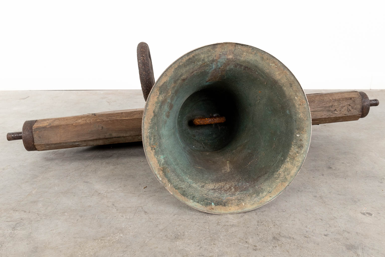 An antique bronze bell mounted on a wood base. 18th C. (W:120 x H:52 x D:36 cm)