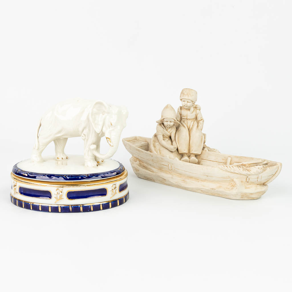 A collection of 2 pieces of Royal Dux porcelain: 'Boys in a boat - Bonbonière with an elephant'. (H:16cm)