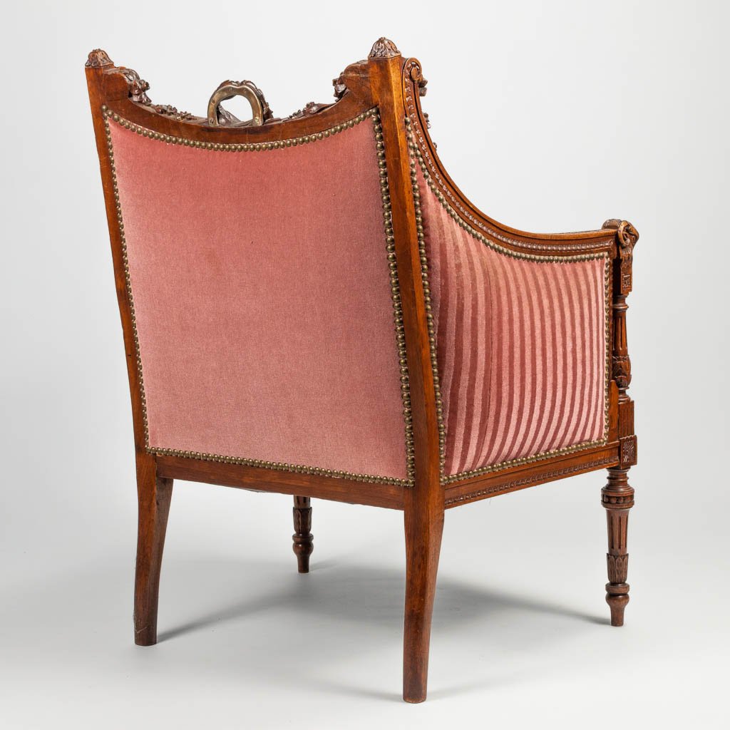An antique chair in Louis XVI style, with sculptured ram