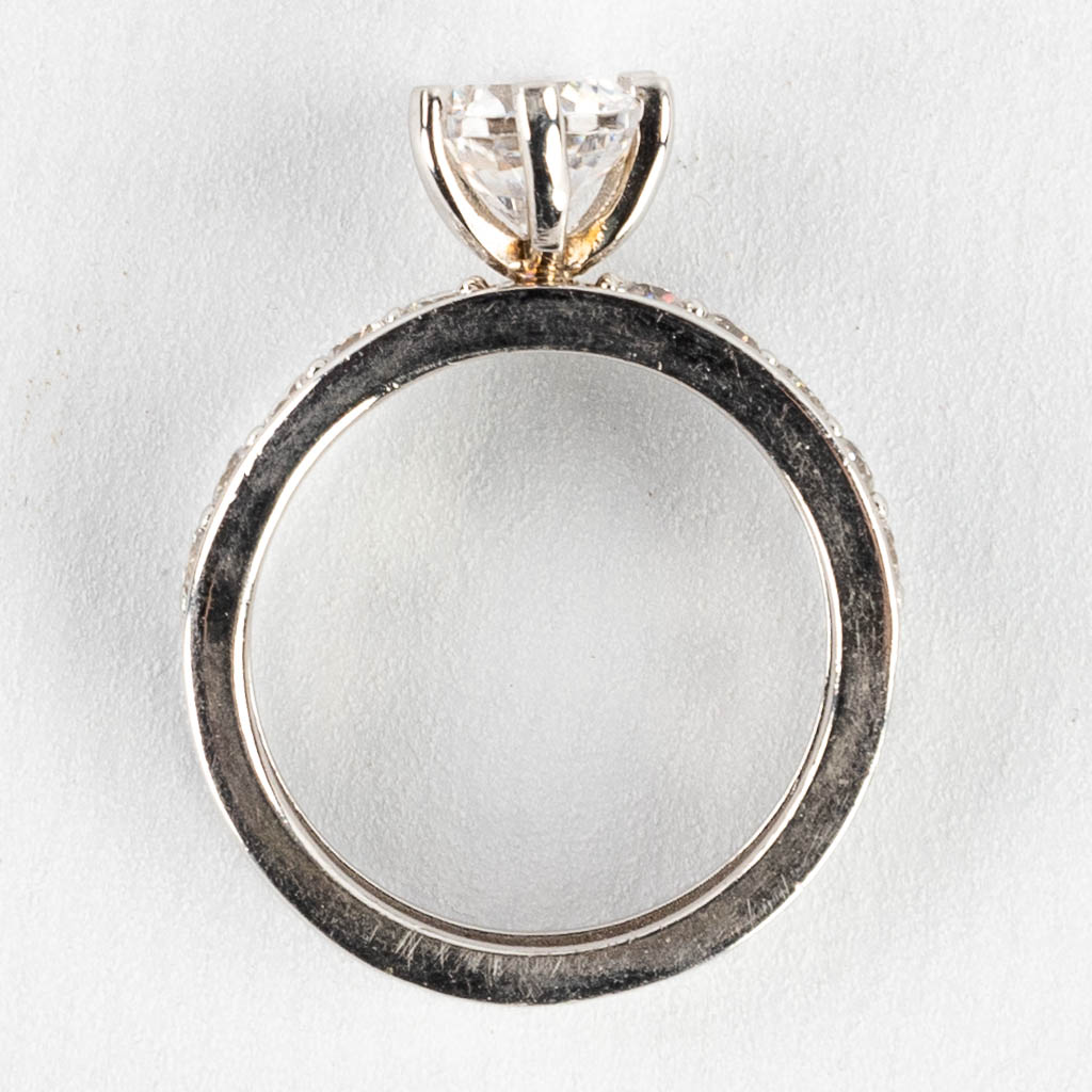 A ring with large solitaire and smaller stones/synthetic stones. Silver, marked 925.