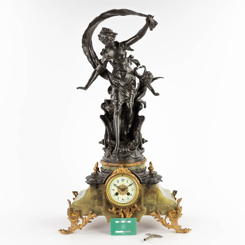 Auguste MOREAU (1834-1917) A mantle clock, spelter on green onyx, 19th C. (D:21 x W:44 x H:63 cm)