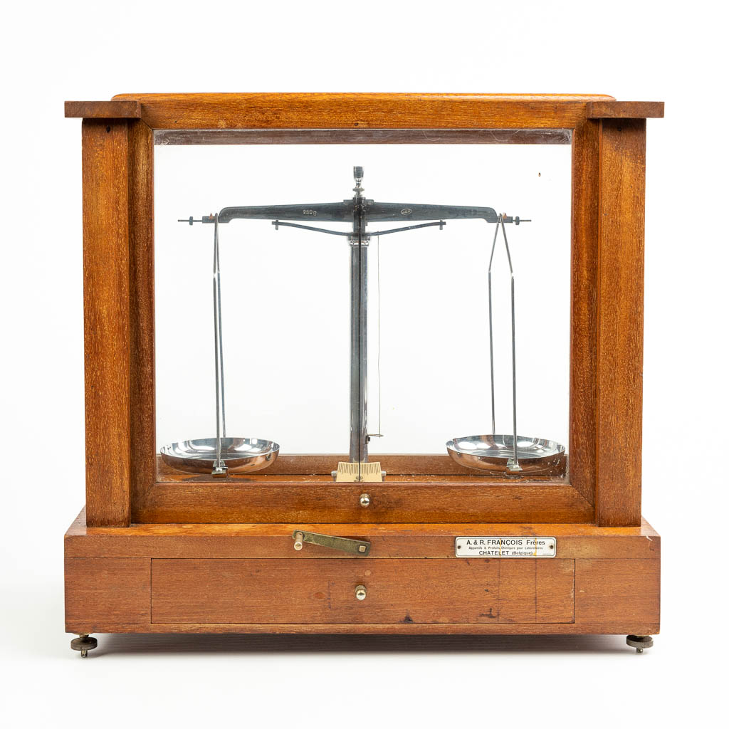A pharmacy precision scale in a box made of wood and glass and marked A & R Francois Frères, Chatelet Belgique. 