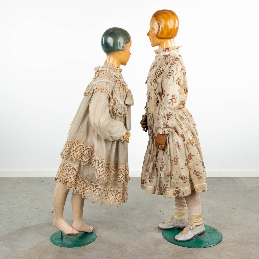 A pair of exceptional fitting dolls, with original clothing. (H:141cm)