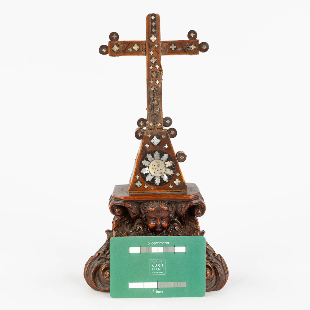 A crucifix made of sculptured palm wood, inlaid with mother of pearl. 19th C. (L: 6 x W: 13 x H: 25,5 cm)