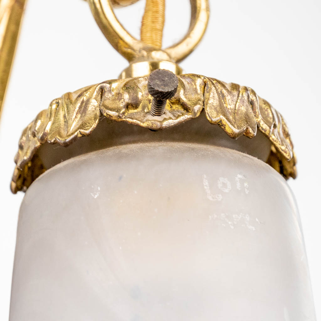 Een art-deco luchter gemaakt uit brons gemonteerd met pâte-de-verre lampkappen en gemerkt Loti, Nancy. (H:80cm)