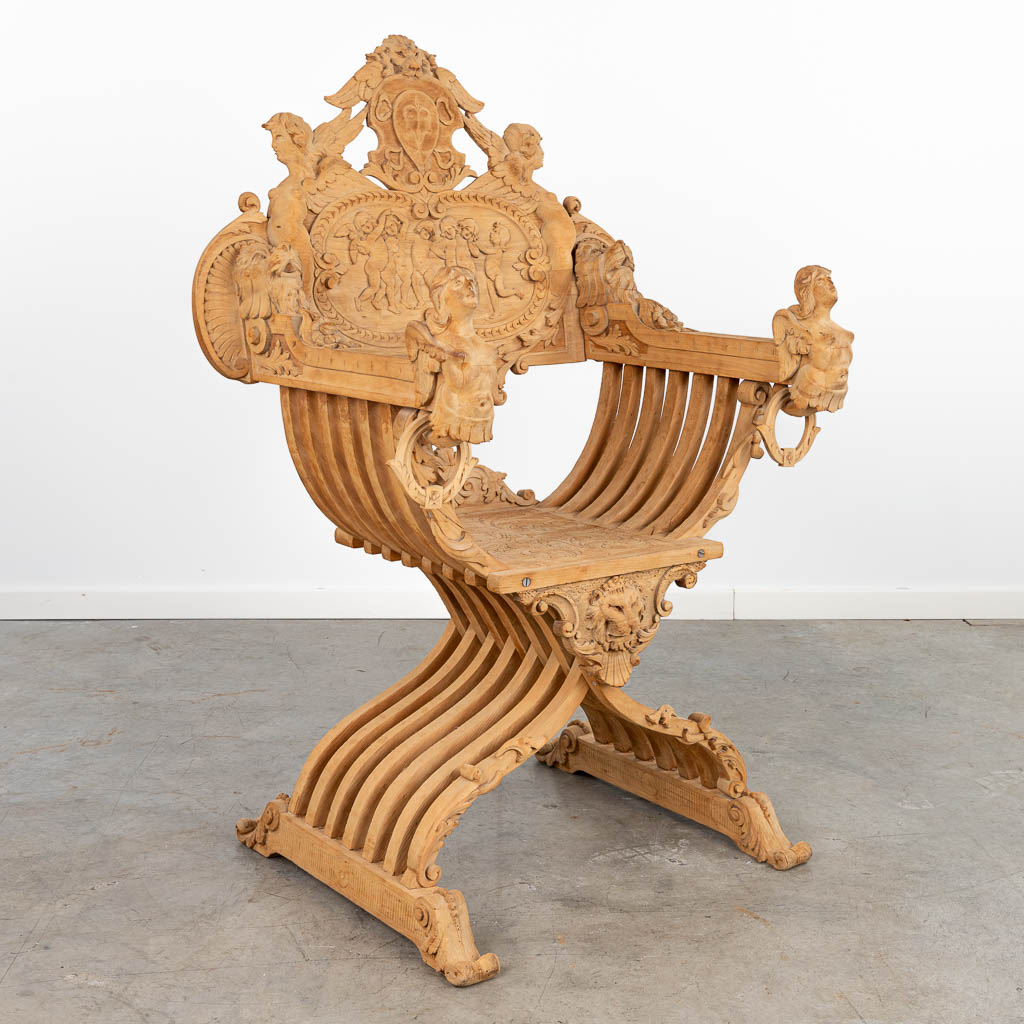 An antique 'Dagobert Chair' made of stripped sculptured wood. (H:121cm)