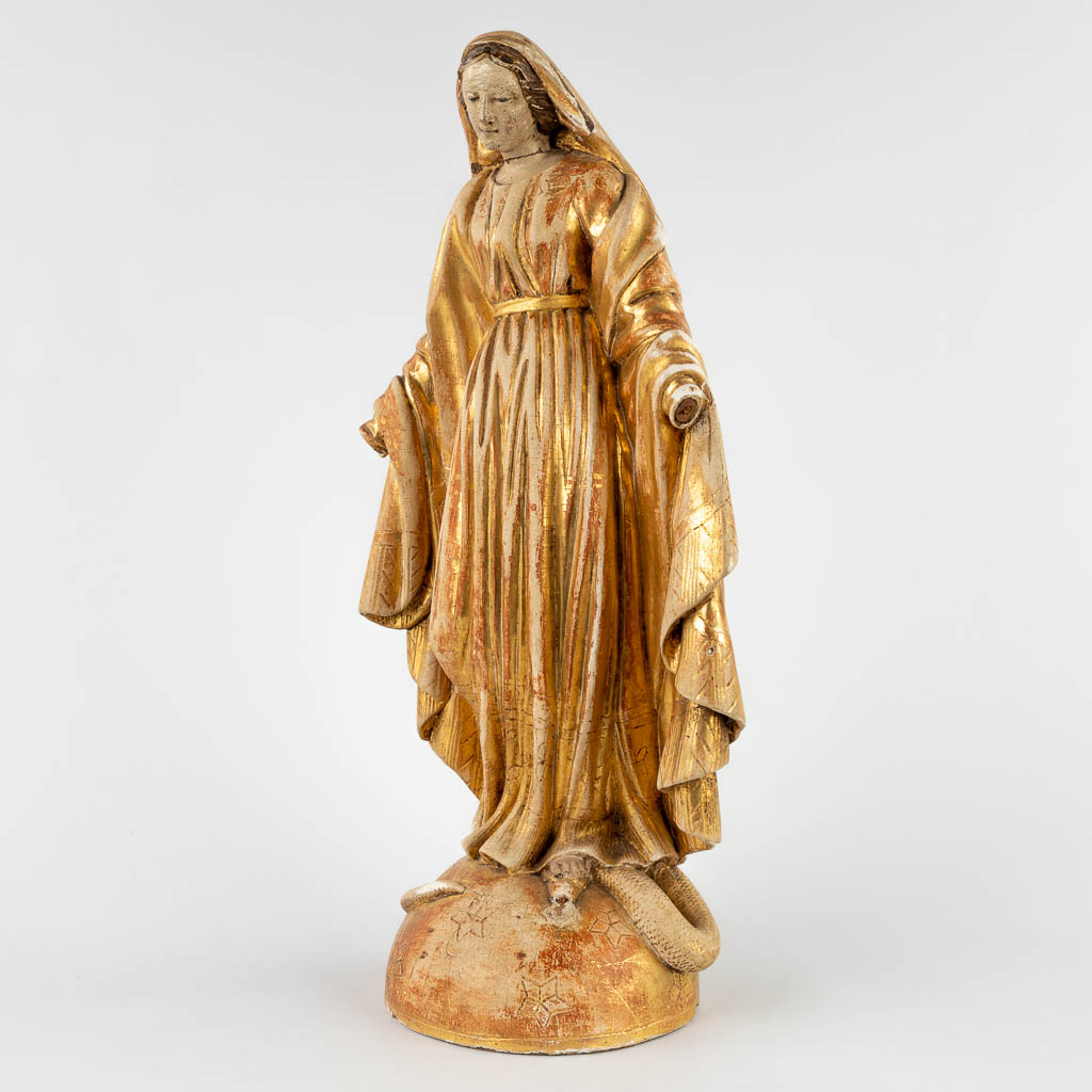 An antique gilt wood figurine of Madonna standing on the crescent moon and serpent. 19th C. (D:15 x W:23 x H:49 cm)