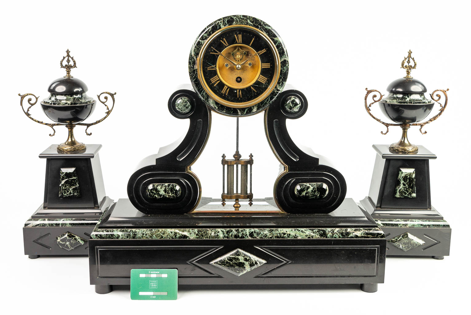 A three-piece mantle garniture clock made of black marble. (H:51cm)