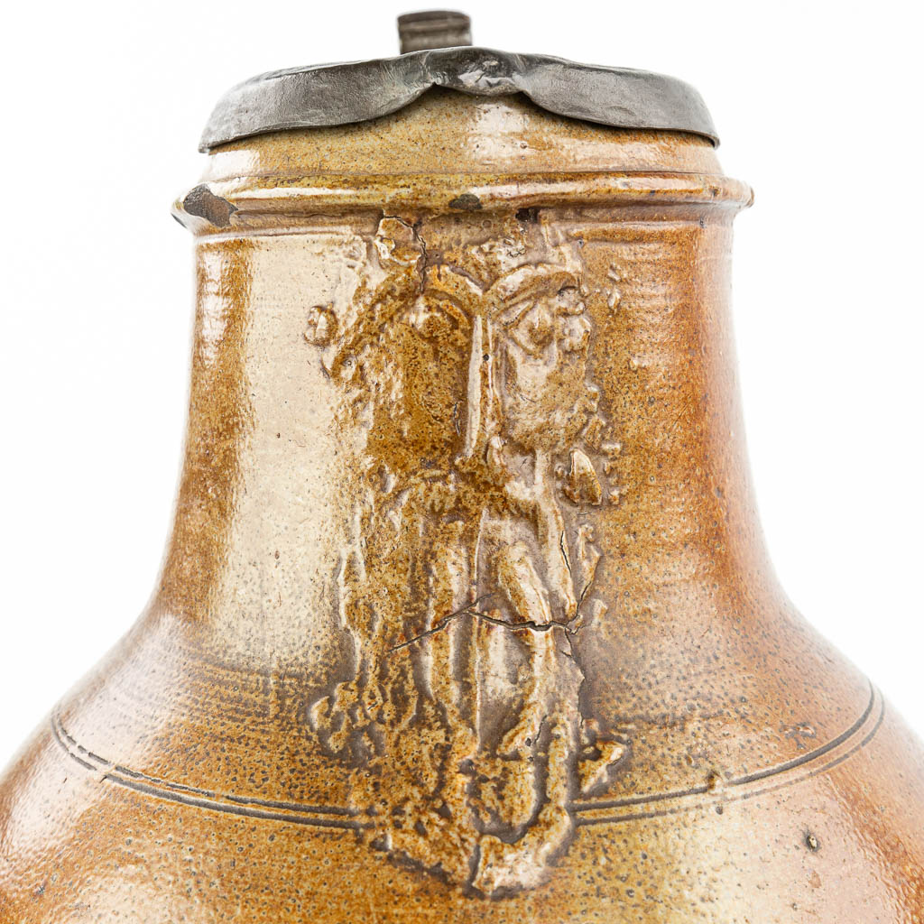 A large and antique Bartmann Jug with lid made of tin. (H:49,5cm)
