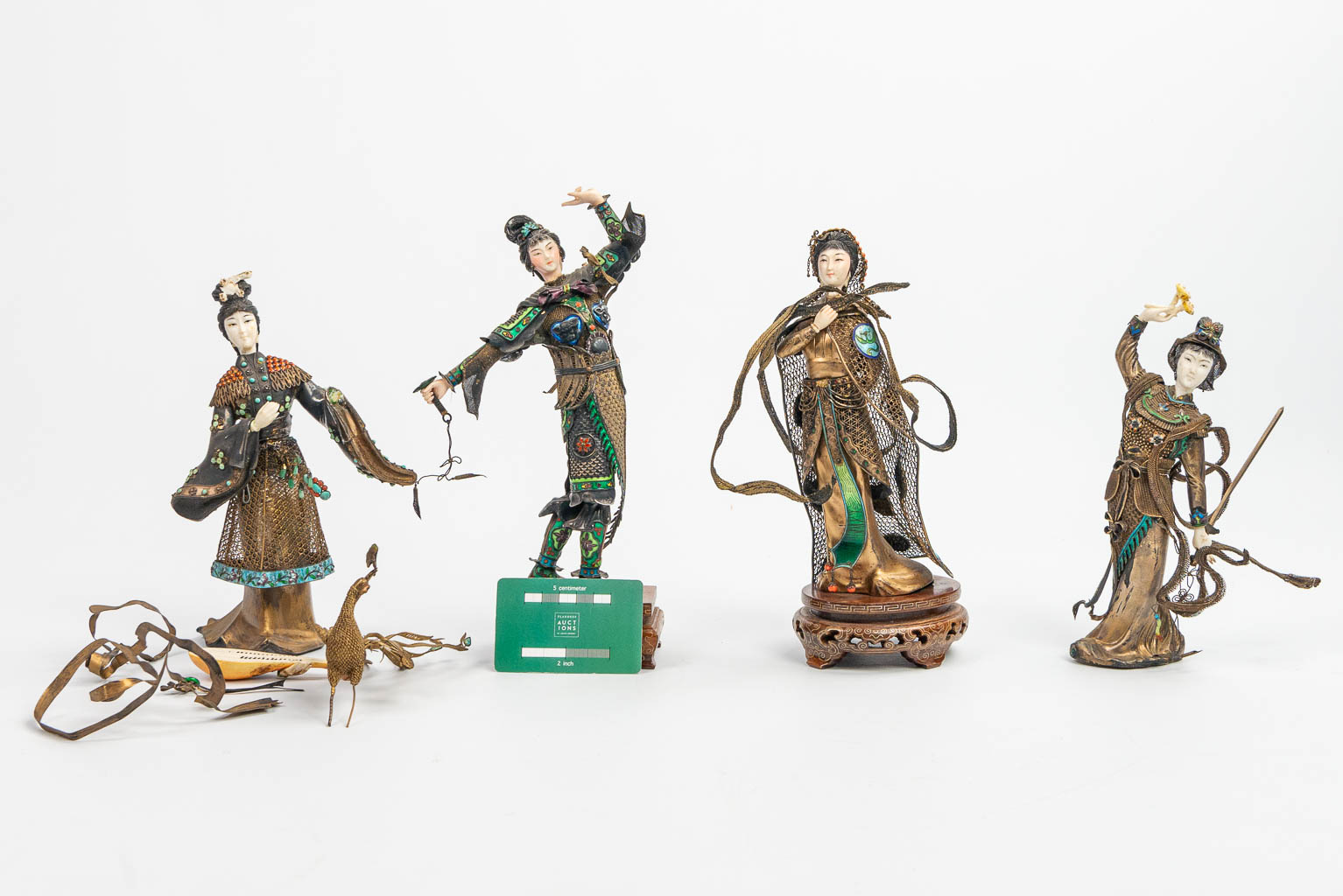A collection of 4 figurines with weapons and music instruments, made of silver and finished with filigrana, cloisonné enamel, c