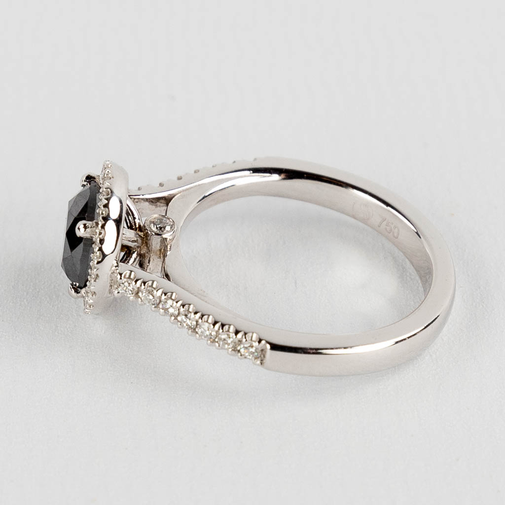 A ring, 18kt white gold with a black diamond, appr. 1.62ct and smaller brilliants, appr. 0.32ct. Ring size: 56.