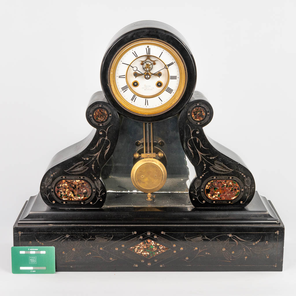 A table clock made of black marble with red marble inlay and a mercury style pendulum. (H:47cm)
