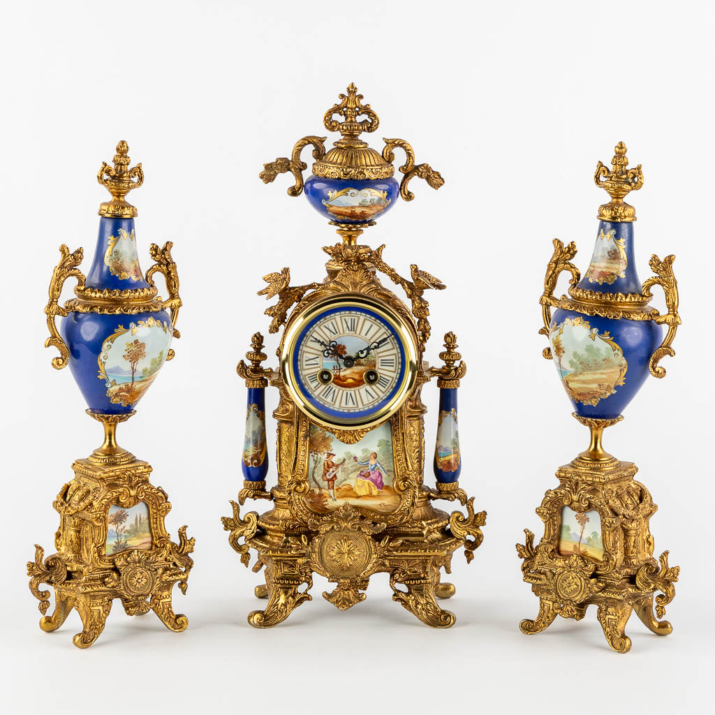A three-piece mantle garniture clock and side pieces, bronze mounted with porcelain. (L:12 x W:20 x H:41 cm)