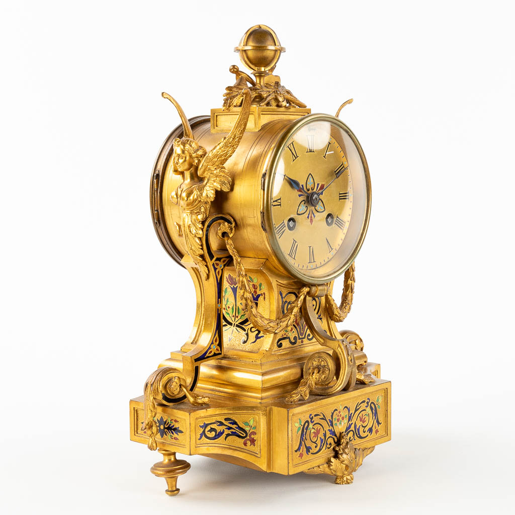 A small mantle clock, bronze decorated with enamel, angels and a globe. 19th C. (L: 12,5 x W: 20 x H: 28 cm)