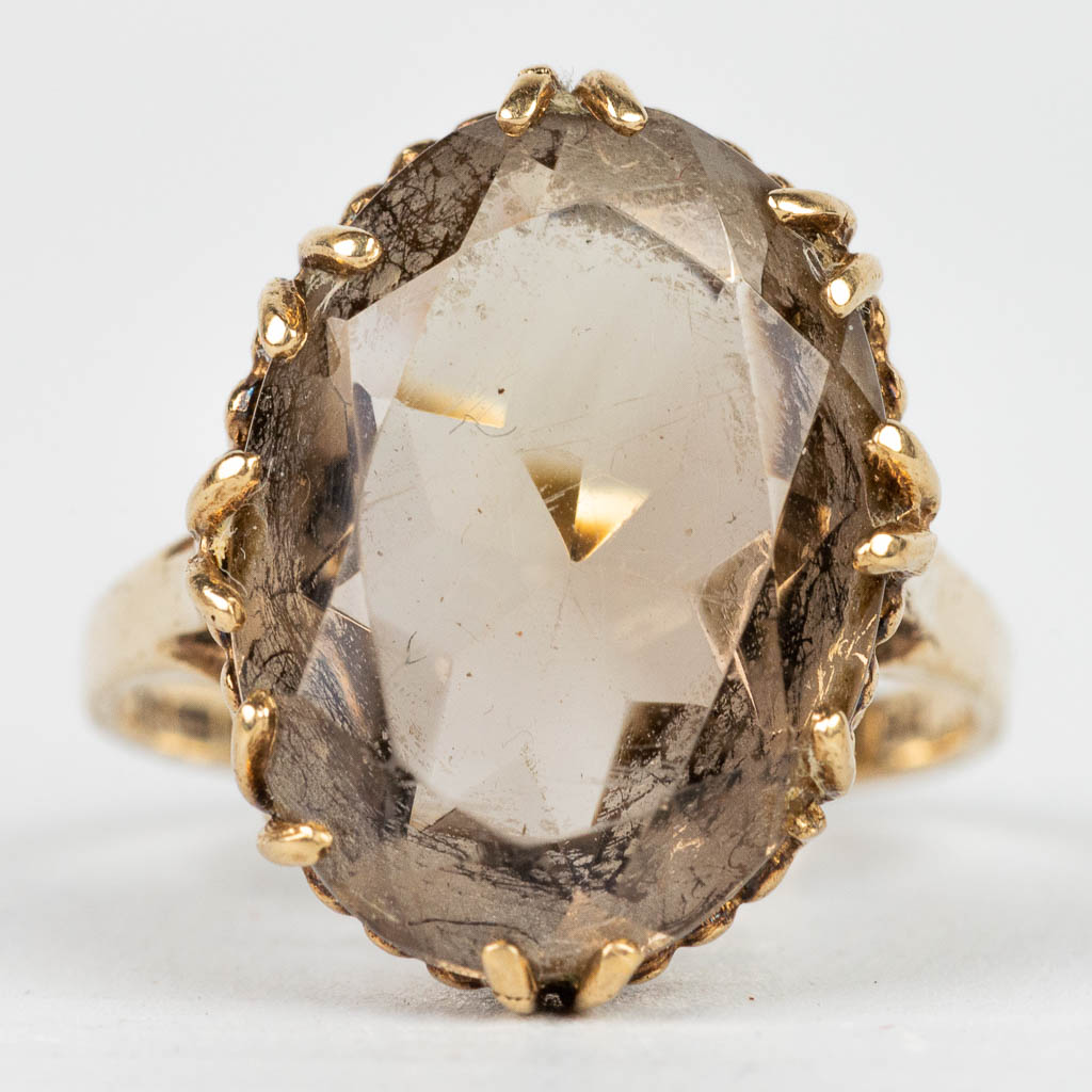 A ring with brown natural stone in a ring made of 9 karat yellow gold. 