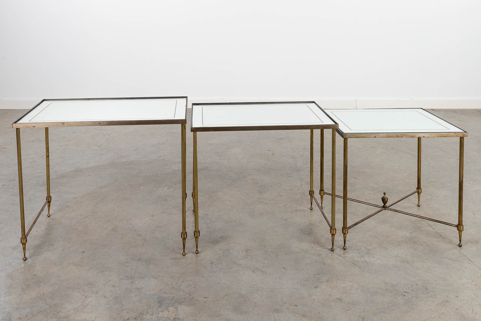 A collection of 3 coffee tables, made of brass and glass, in the style of Maison Jansen. (H:45cm)
