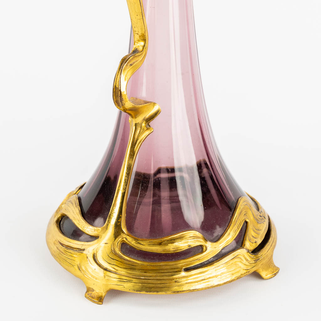 A pitcher, gilt metal and purple glass, Art Nouveau. (L:16 x W:20 x H:39 cm)