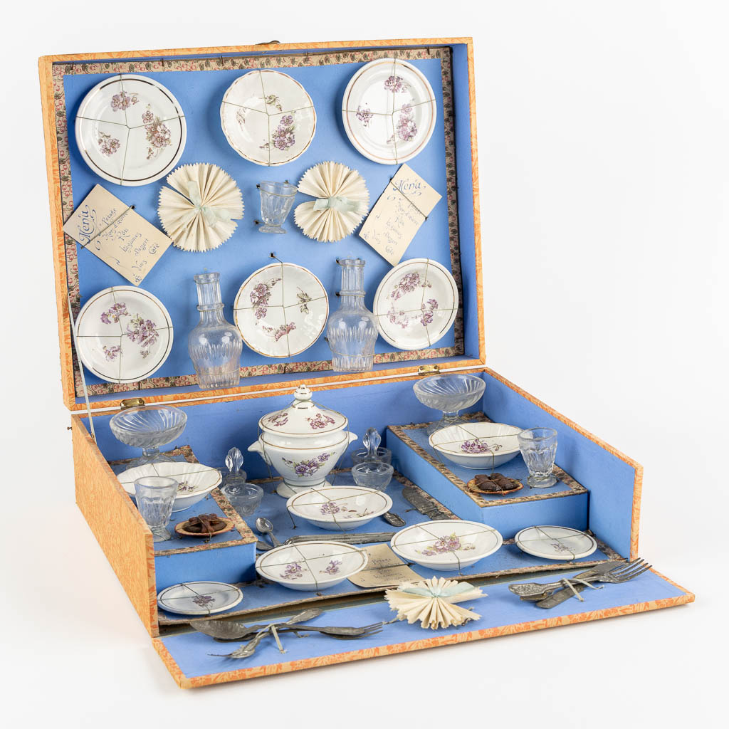 A children's porcelain service and flatware, 'Dinette', in the original box. (L:28 x W:36 x H:12 cm)