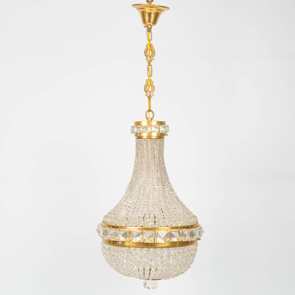 A Sac-à-Perles chandelier made of brass and glass in the Czech Republic during the second half of the 20th century. 