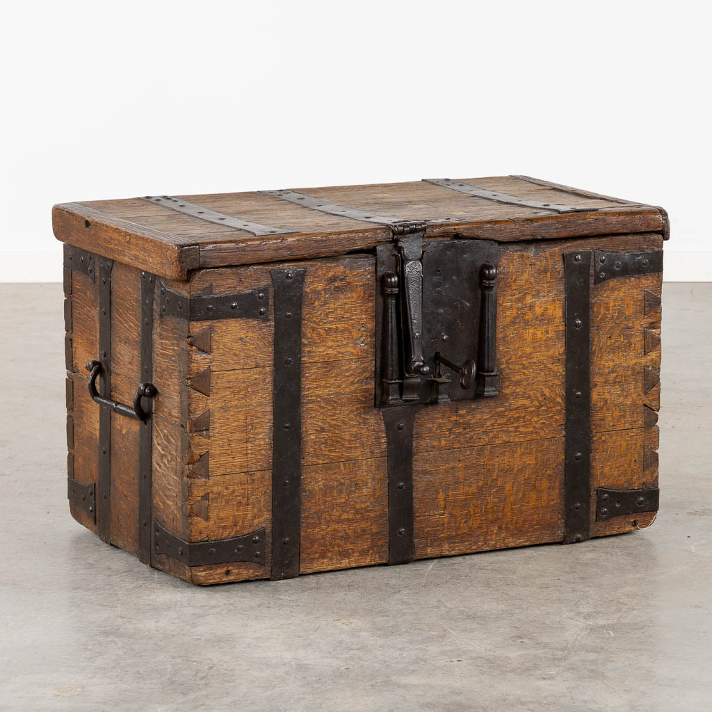 An antique Money box, wood mounted with wrought iron, circa 1500. (L:77 x W:44 x H:50 cm)