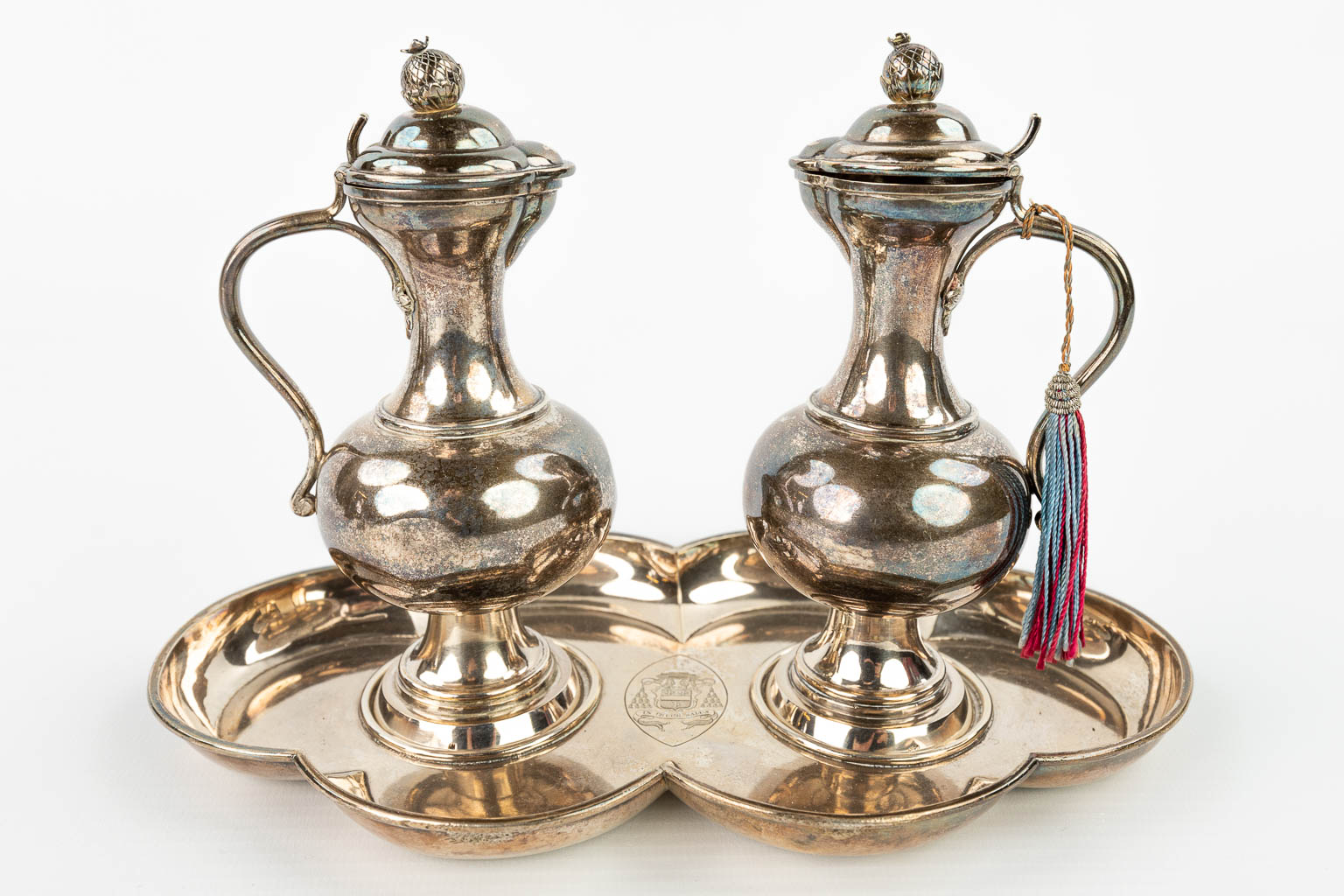 A collection of silver and silver plated items: Chrismatorium, Staff of Our Lady, Two crowns and a pair of oil and vinegar cruet