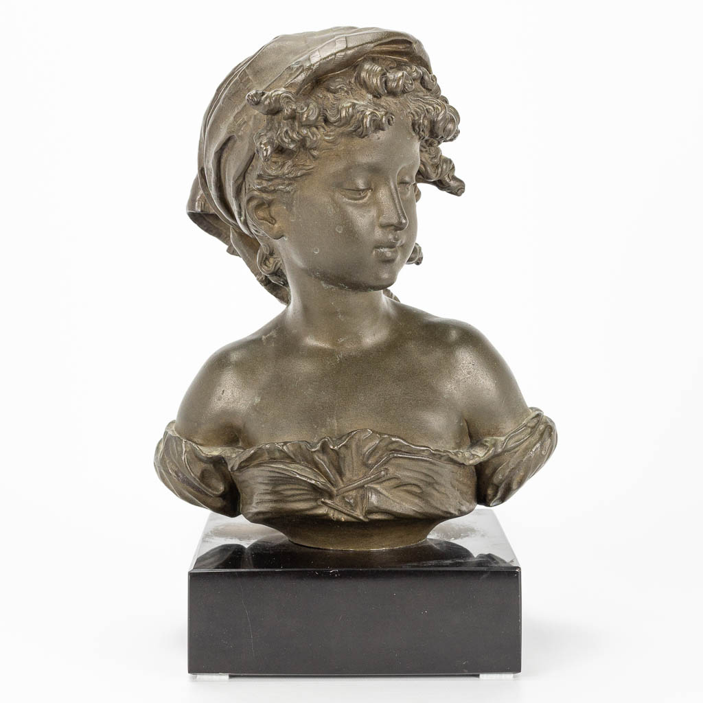 A bust of a young lady, made of bronze and marked Compagnie des bronzes, Bruxelles. 