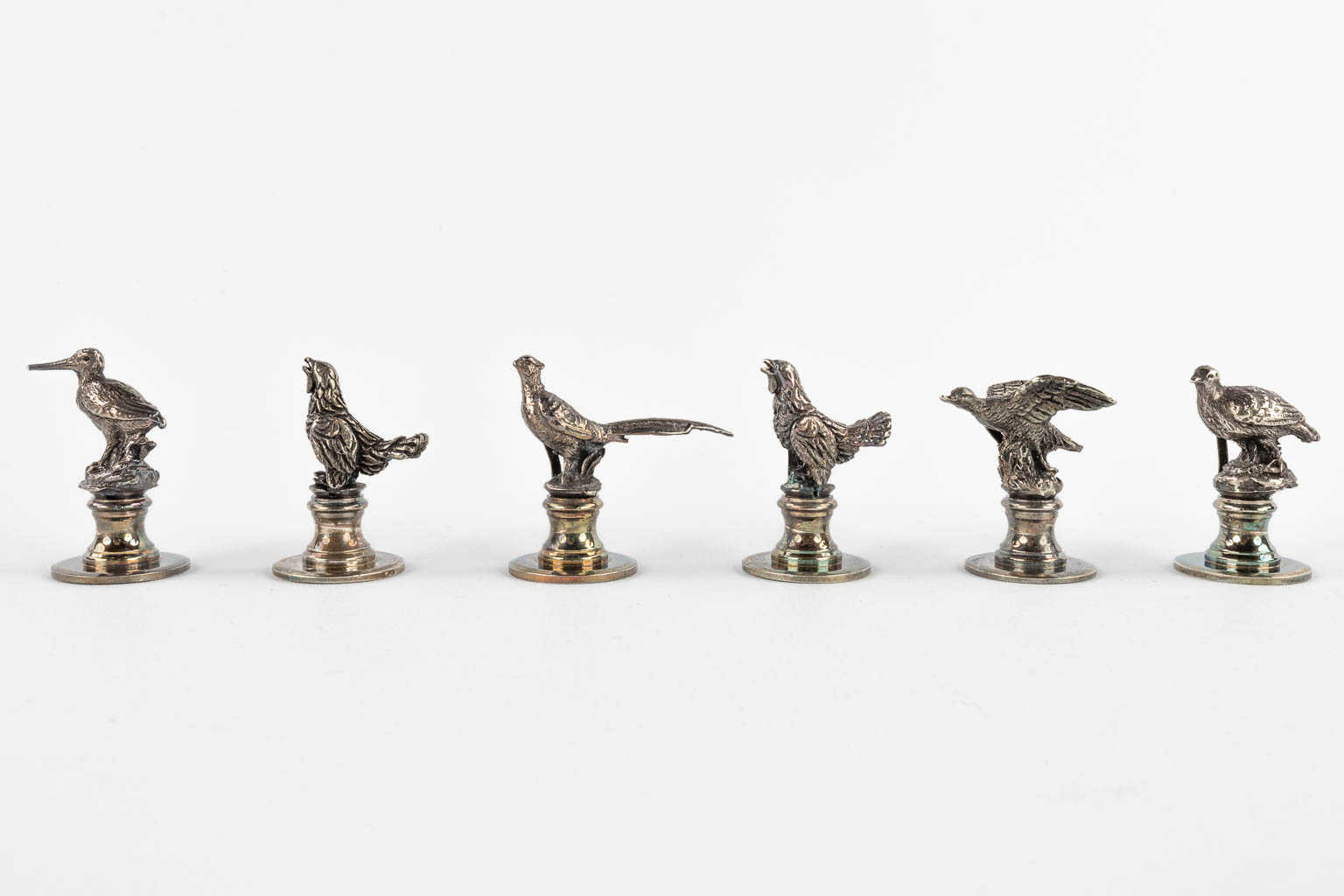 12 figurative animal place or menu card holders, silver-plated bronze. (H:5 cm)