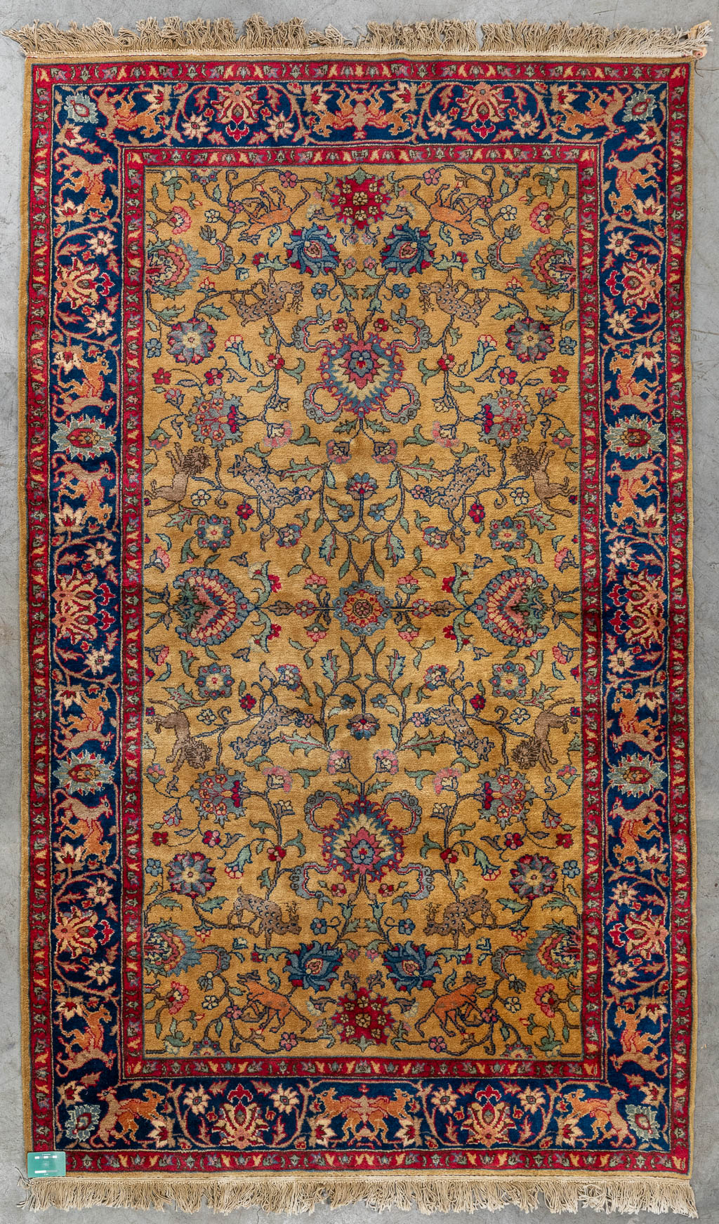An Antique Oriental hand-made carpet decorated with animals, Kashan. (D:253 x W:153 cm)
