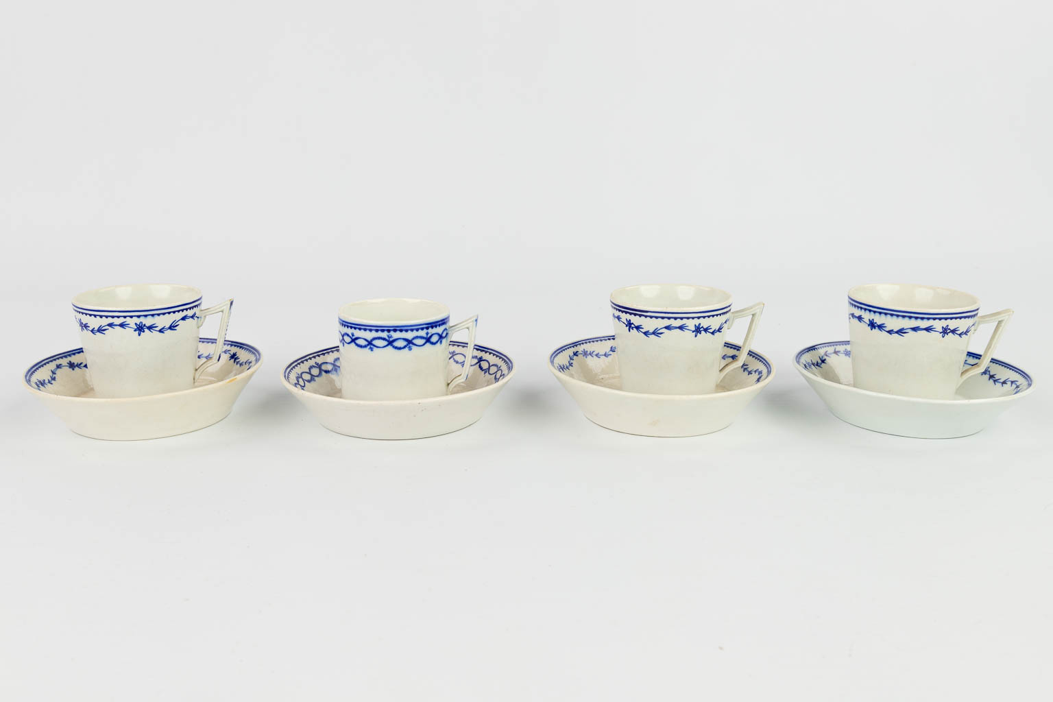 A collection of 3 plates, 4 cups and saucers made in Doornik. The first half of the 19th century. 